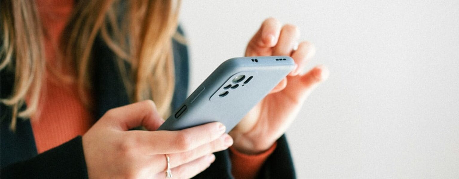 Woman holding phone for digital distribution